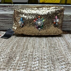 Torrid. Makeup bag. New with tag 8-1-2 width 6”length.  Gold glitter